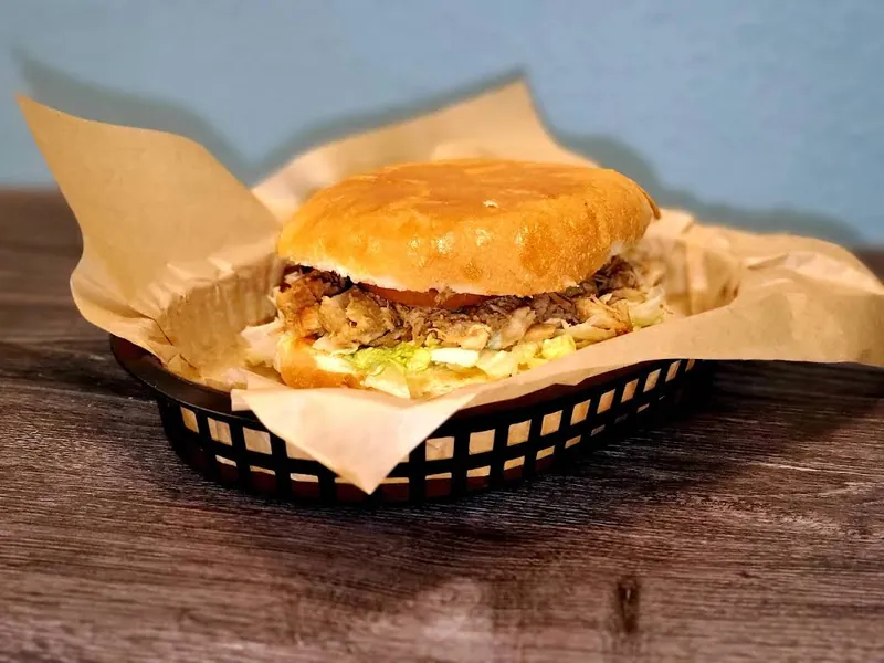 Sandwich on a bun in a paper-lined basket